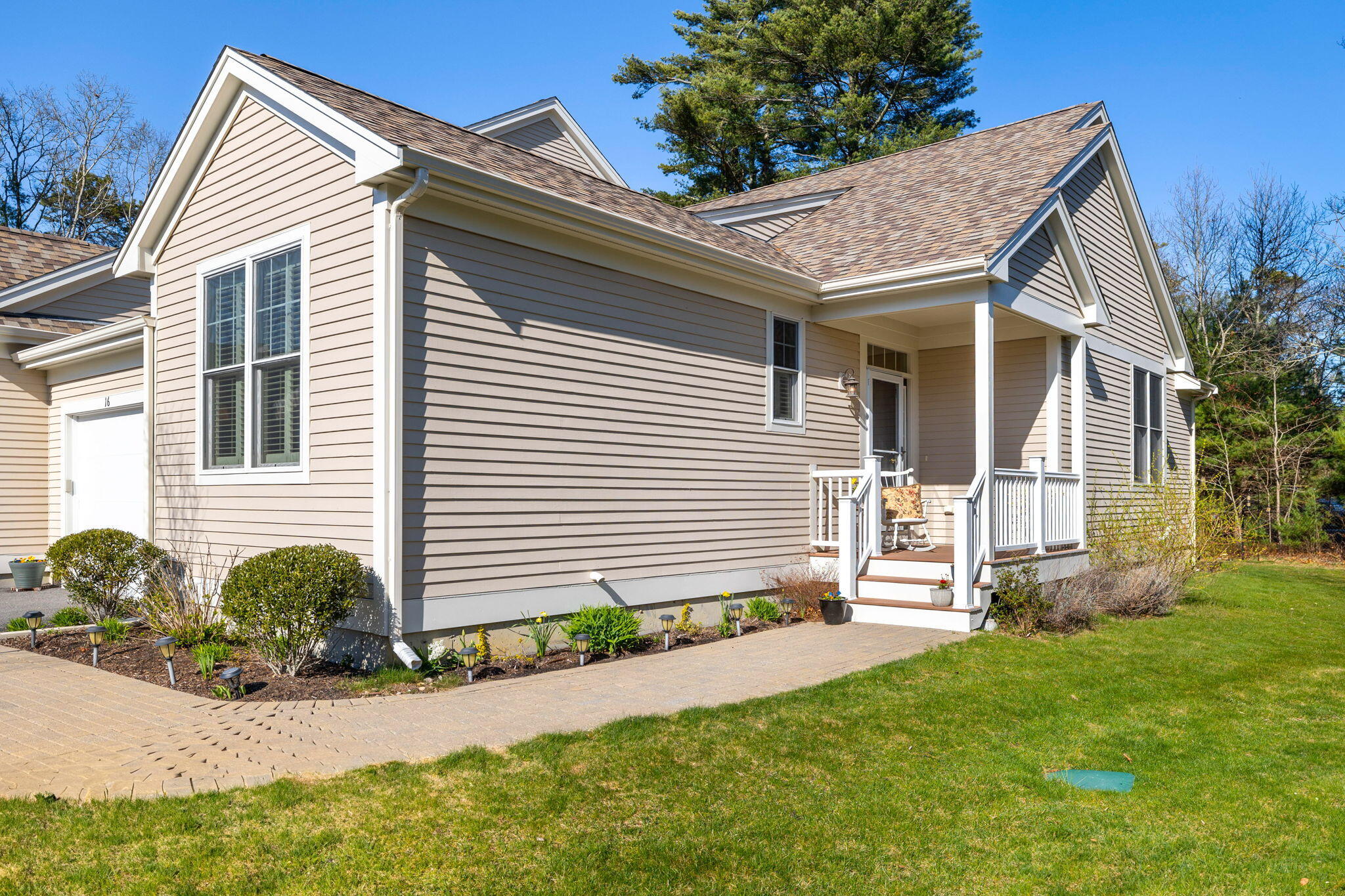 16 Grey Hawk Drive, Unit 16 Mashpee, MA 02649 - Photo 3 of 29 a view of a house with a yard and plants