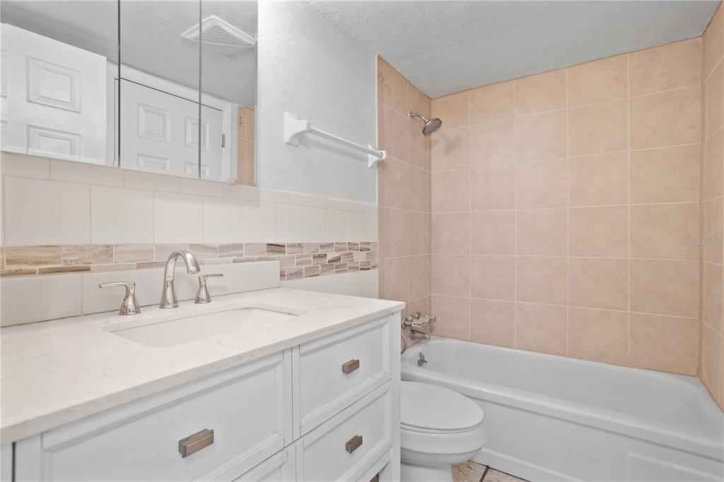 303 Ridge Boulevard, Unit 110 South Daytona, FL 32119 - Photo 13 of 33 a bathroom with a sink a toilet and a bathtub