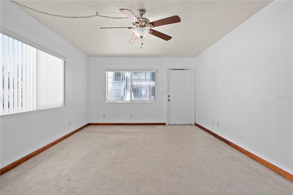 303 Ridge Boulevard, Unit 110 South Daytona, FL 32119 - Photo 18 of 33 an empty room with windows and fan