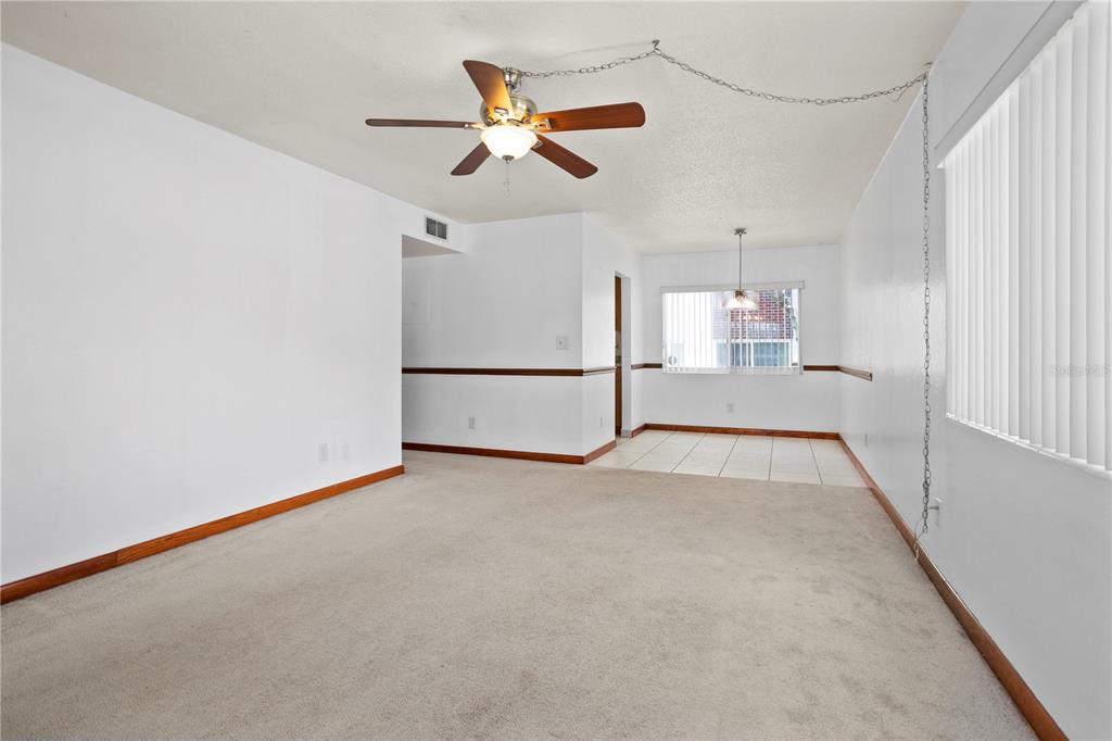 303 Ridge Boulevard, Unit 110 South Daytona, FL 32119 - Photo 19 of 33 a view of a livingroom with a ceiling fan and window