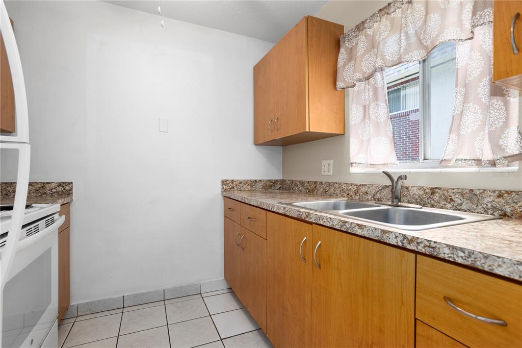 303 Ridge Boulevard, Unit 110 South Daytona, FL 32119 - Photo 22 of 33 a bathroom with a granite countertop sink and a mirror
