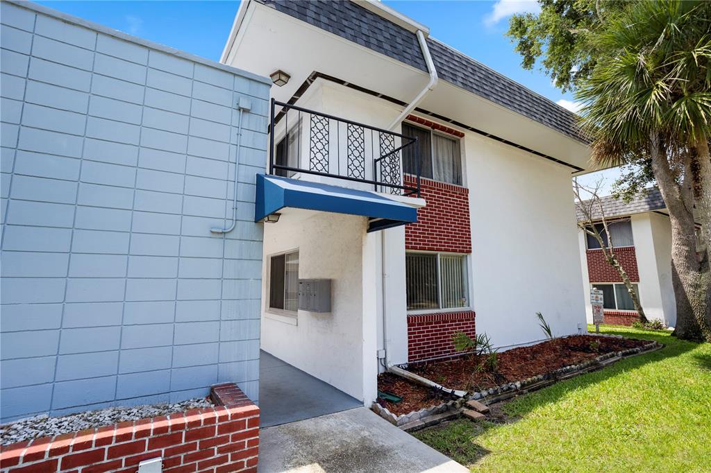 303 Ridge Boulevard, Unit 110 South Daytona, FL 32119 - Photo 3 of 33 a view of a backyard with chairs and a potted plant