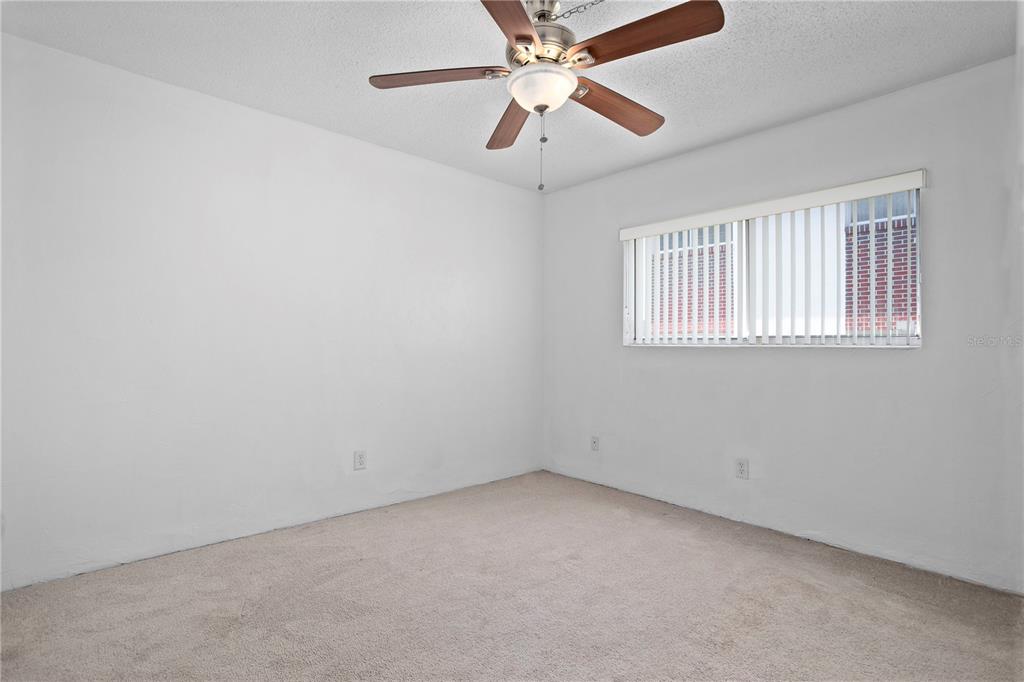 303 Ridge Boulevard, Unit 110 South Daytona, FL 32119 - Photo 7 of 33 an empty room with a window and a fan