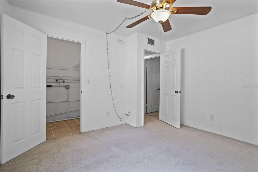 303 Ridge Boulevard, Unit 110 South Daytona, FL 32119 - Photo 8 of 33 an empty room with closet and a ceiling fan