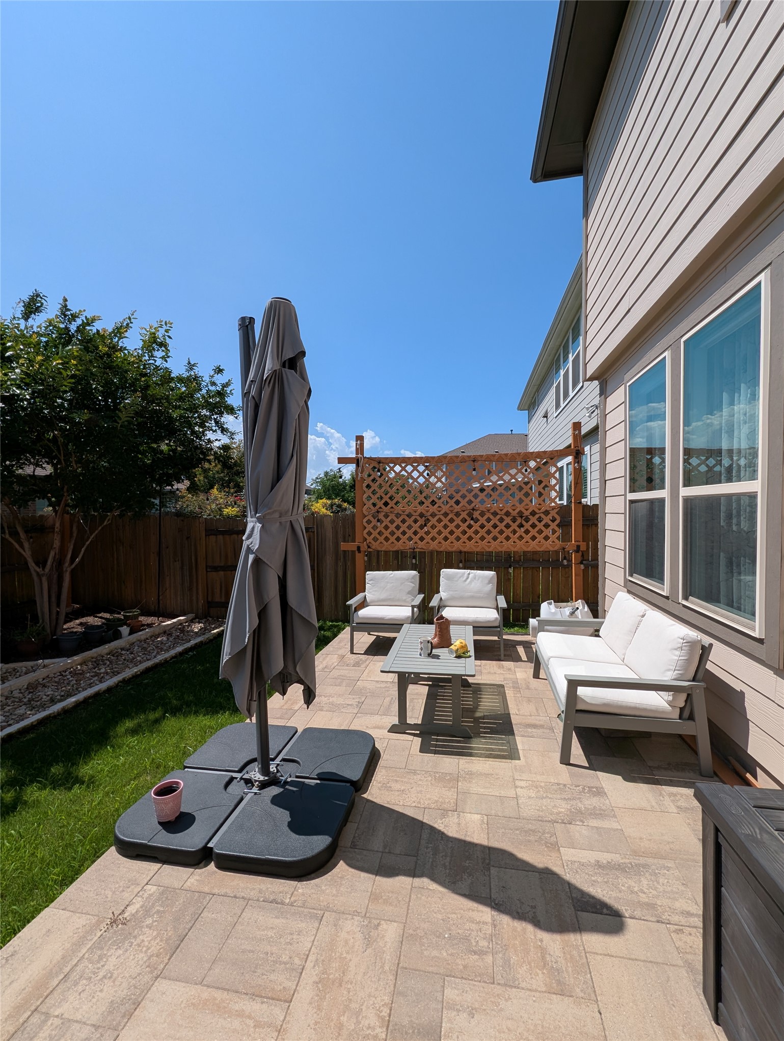 14502 McCoy Loop Austin, TX 78717 - Photo 25 of 26 Paver patio featuring a wooden privacy screen, fencing, and a manicured lawn