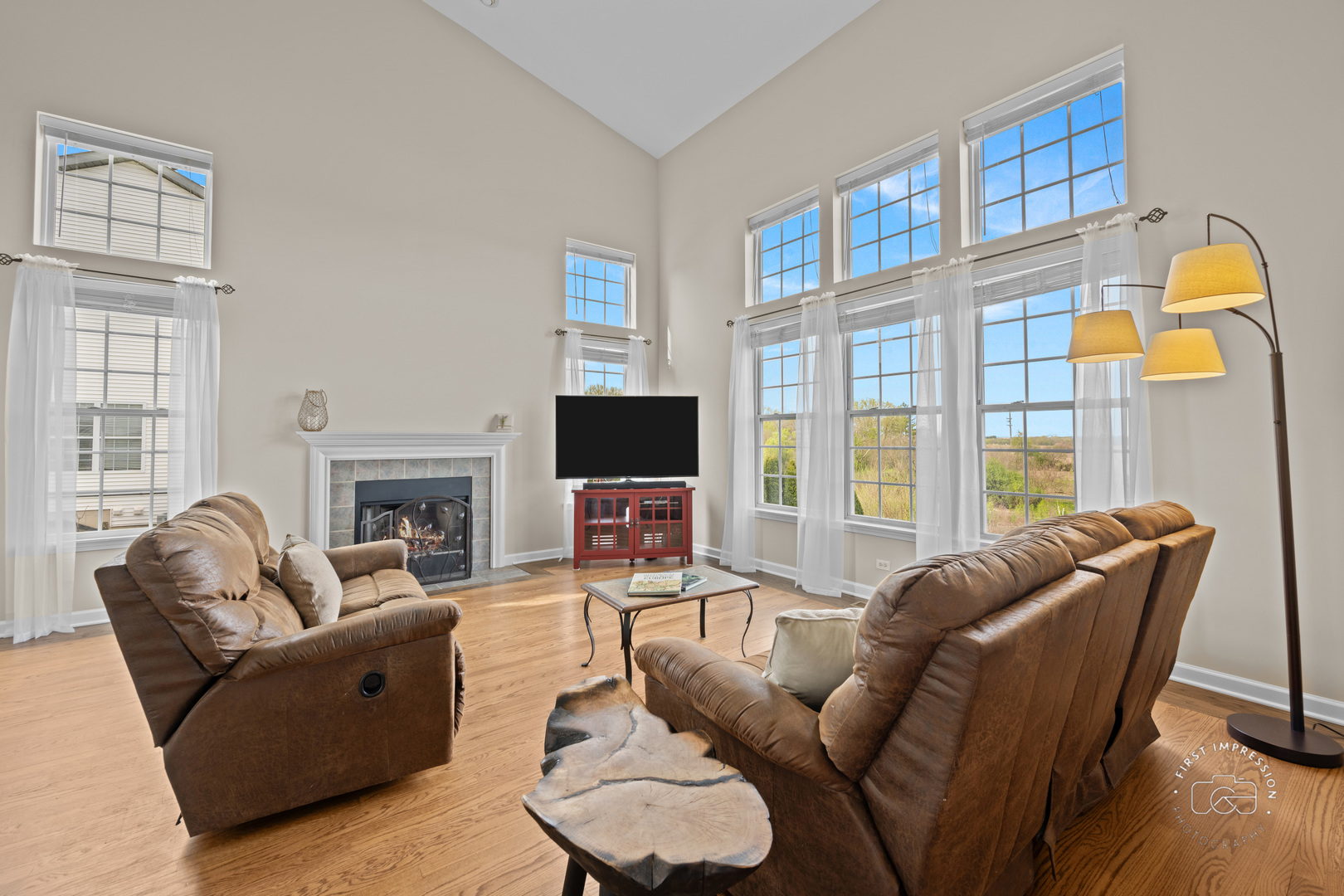 334 Willowbrook Way Geneva, IL 60134 - Photo 12 of 34 a living room with furniture a fireplace and a flat screen tv