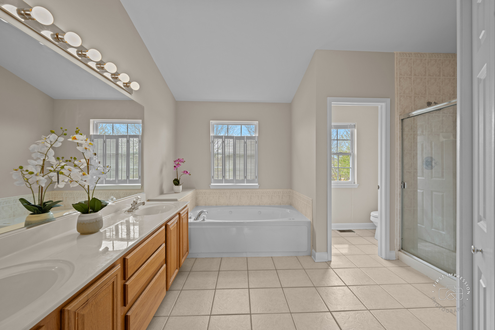 334 Willowbrook Way Geneva, IL 60134 - Photo 15 of 34 a spacious bathroom with a granite countertop sink a mirror and a bathtub