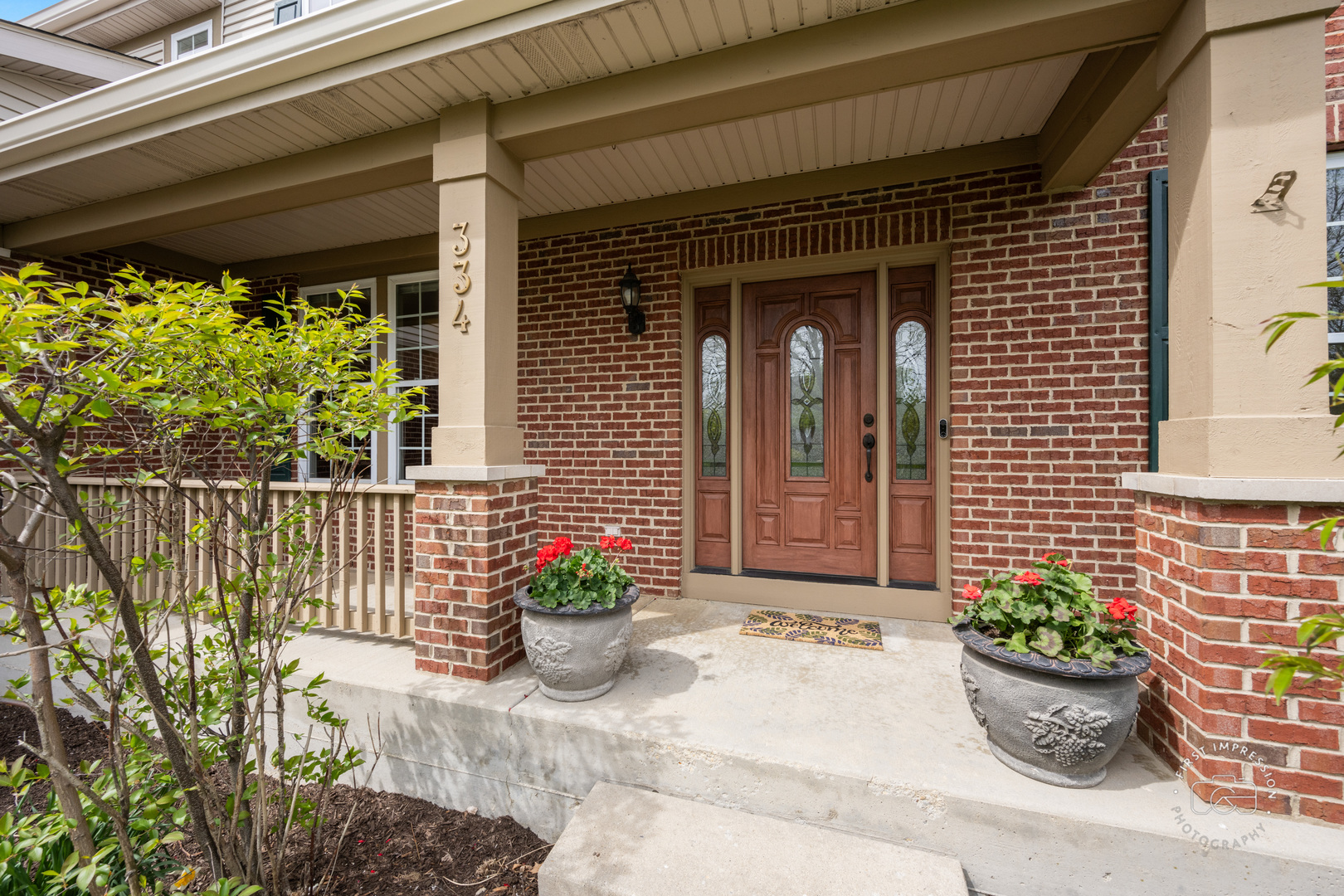 334 Willowbrook Way Geneva, IL 60134 - Photo 2 of 34 a view of a entryway door front of house with potted plants