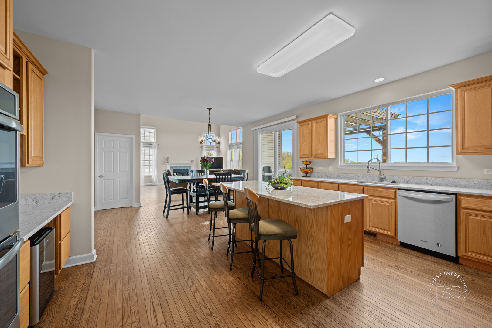 334 Willowbrook Way Geneva, IL 60134 - Photo 6 of 34 a kitchen with stainless steel appliances granite countertop wooden floors and table