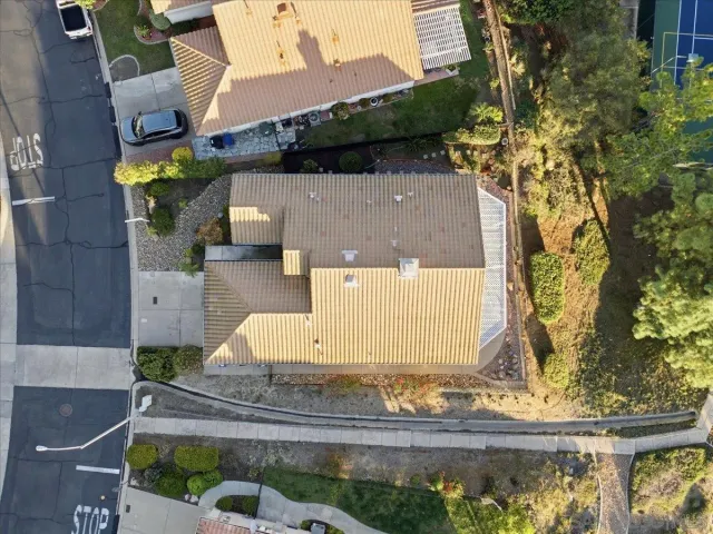 an aerial view of a house with a yard and garden