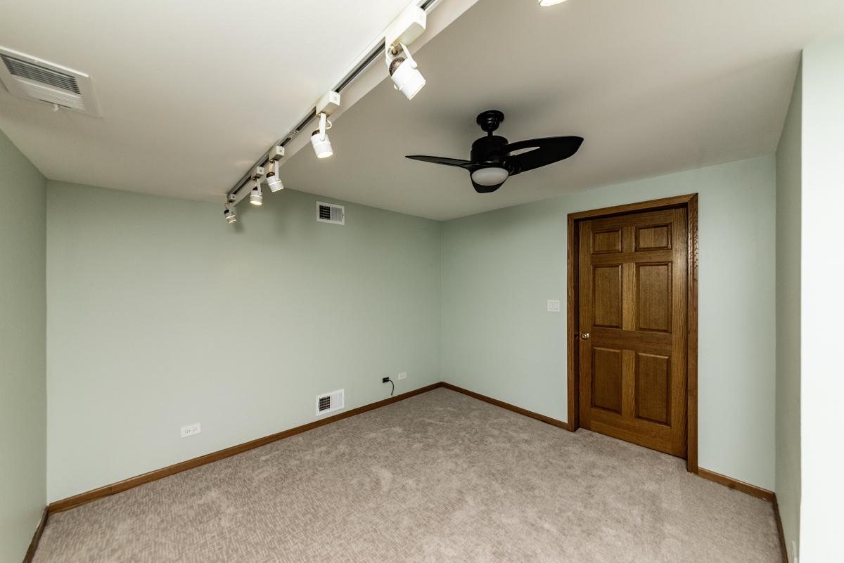 4625 North Dover Street, Unit G Chicago, IL 60640 - Photo 11 of 26 an empty room with a ceiling fan and window