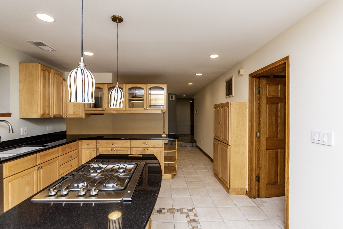 4625 North Dover Street, Unit G Chicago, IL 60640 - Photo 4 of 26 a kitchen with stainless steel appliances granite countertop a refrigerator a sink and a stove