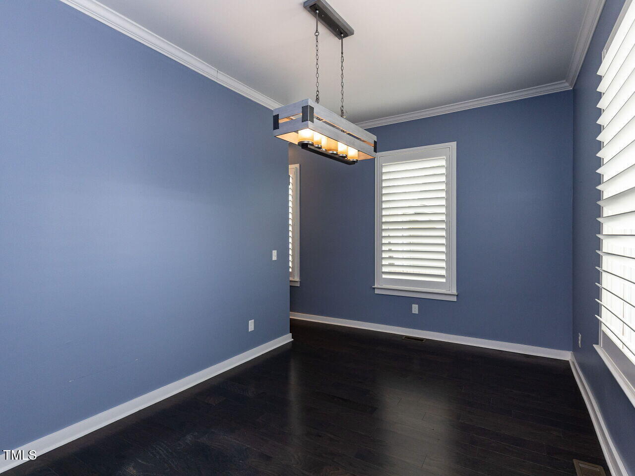 314 Gray Avenue Durham, NC 27701 - Photo 11 of 30 an empty room with wooden floor and windows
