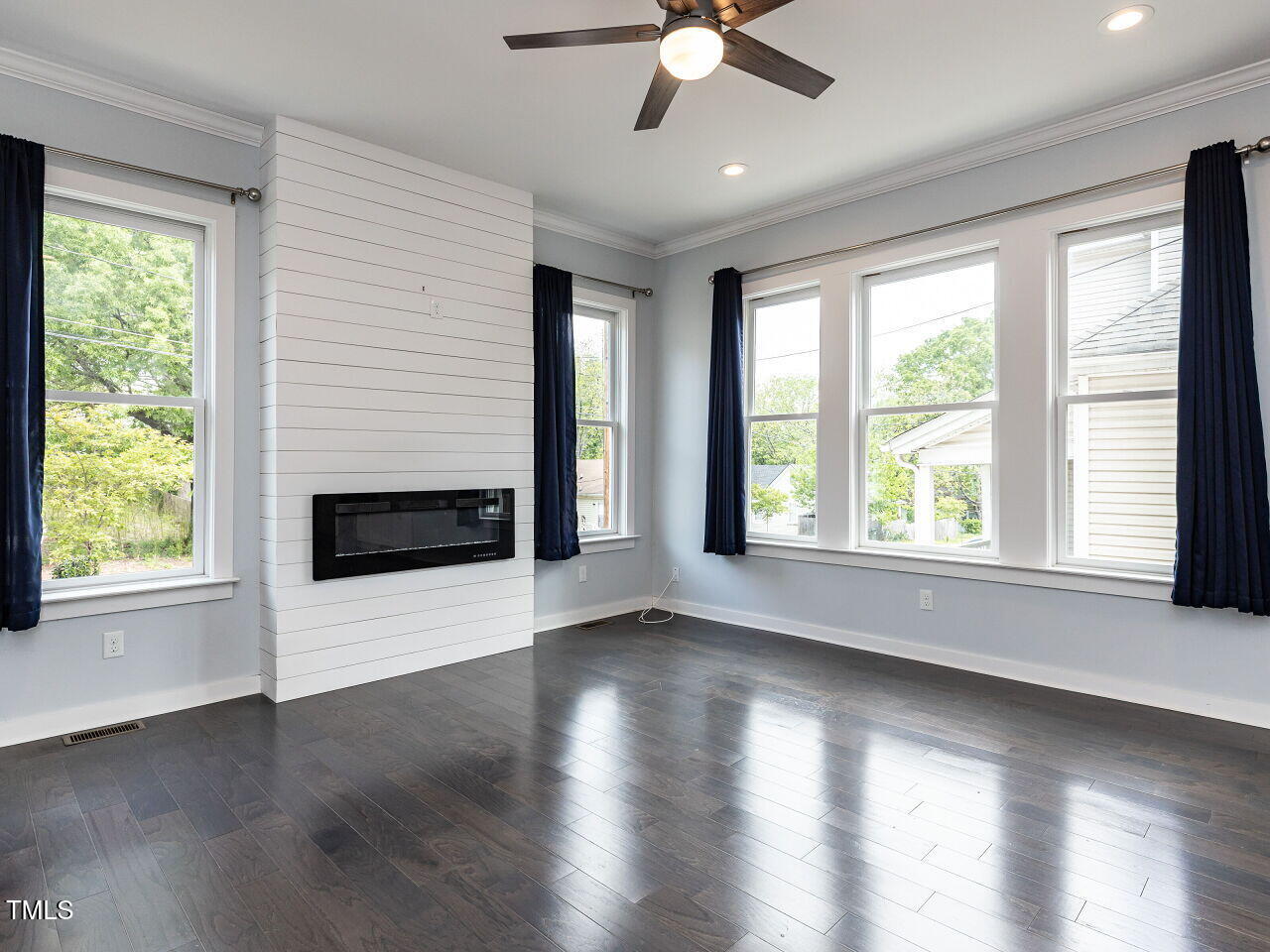 314 Gray Avenue Durham, NC 27701 - Photo 6 of 30 a view of an empty room with wooden floor and a window