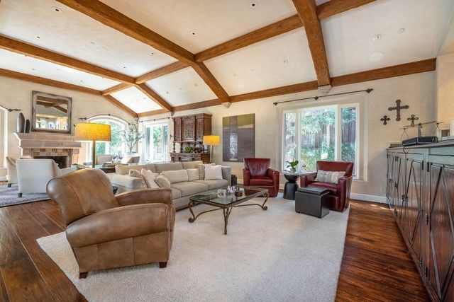 a kitchen with a stove a refrigerator and a fireplace