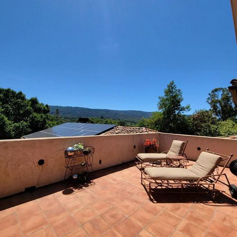 a view of a terrace with couches and sky view