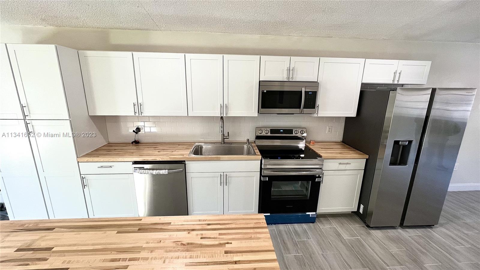 Sunset Miami, FL 33173 - Photo 11 of 41 a kitchen with a stove microwave and refrigerator