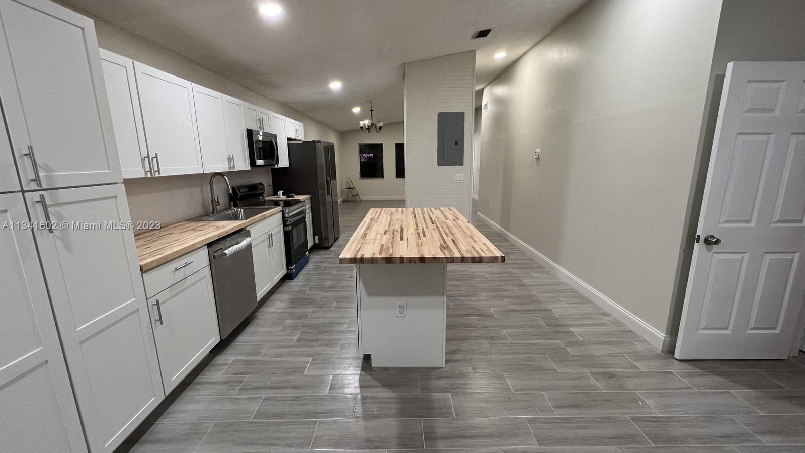 Sunset Miami, FL 33173 - Photo 14 of 41 a kitchen with stainless steel appliances granite countertop a refrigerator a stove top oven and sink
