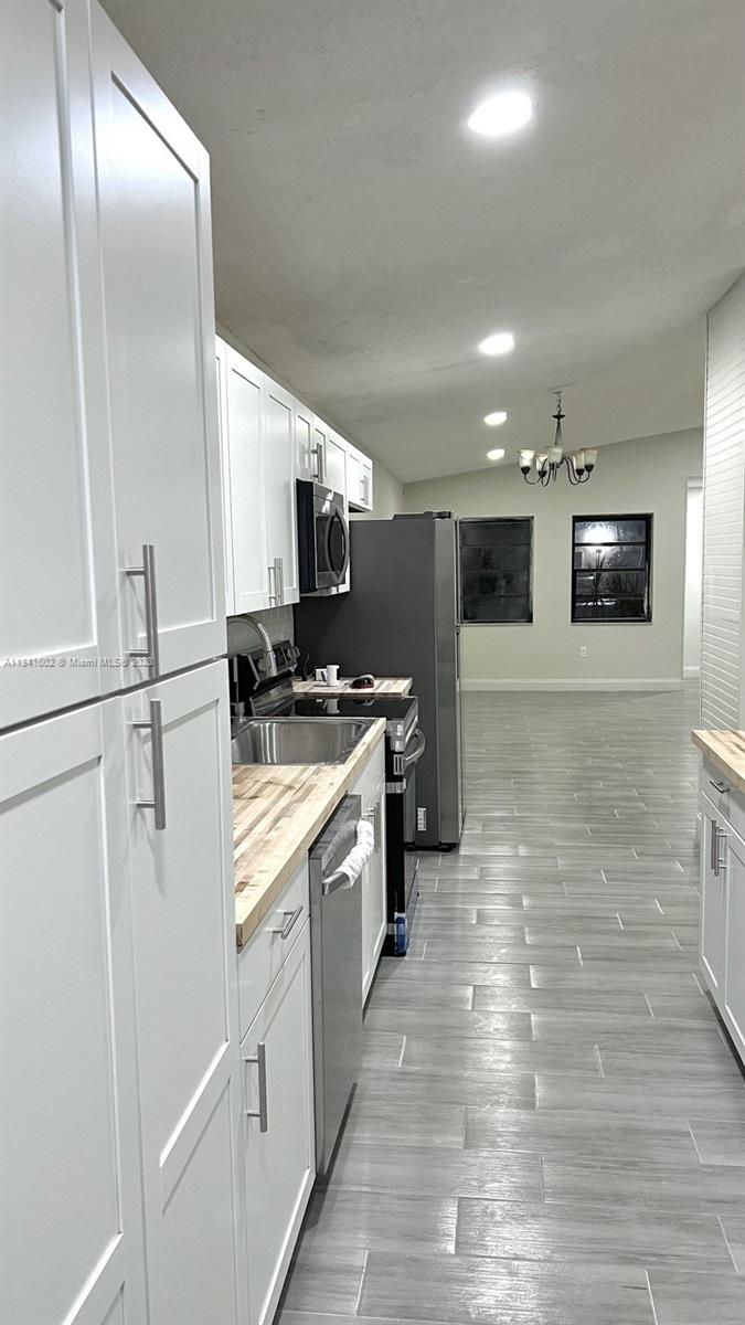 Sunset Miami, FL 33173 - Photo 18 of 41 a kitchen with stainless steel appliances granite countertop a refrigerator a stove and a sink