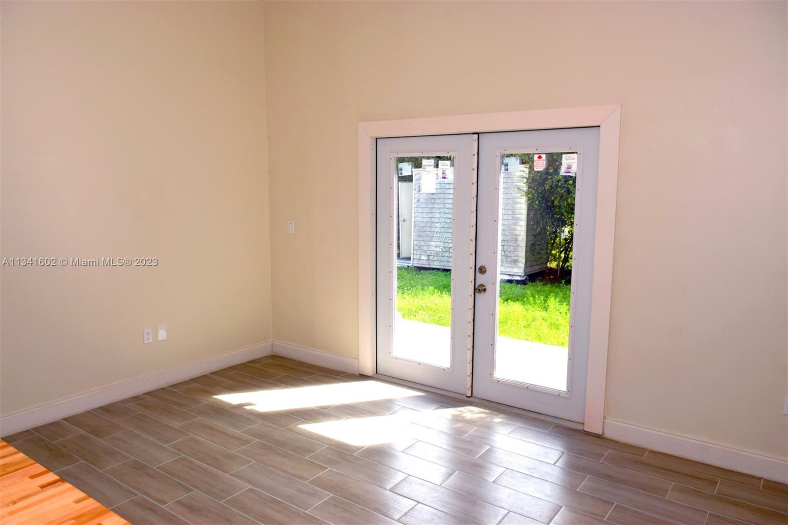 Sunset Miami, FL 33173 - Photo 21 of 41 wooden floor in an empty room with a window
