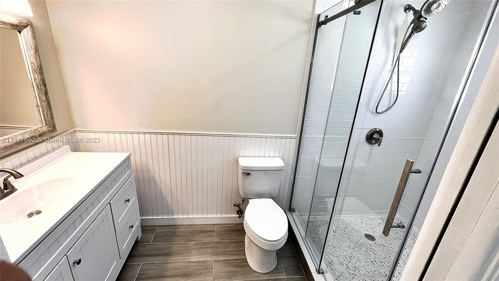 Sunset Miami, FL 33173 - Photo 25 of 41 a bathroom with a granite countertop sink toilet and shower