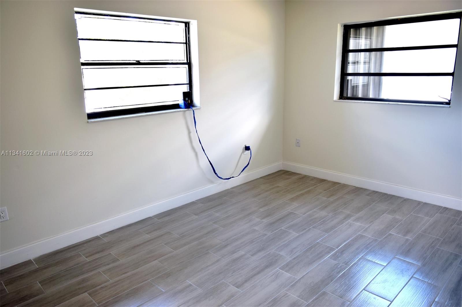 Sunset Miami, FL 33173 - Photo 31 of 41 an empty room with wooden floor and windows