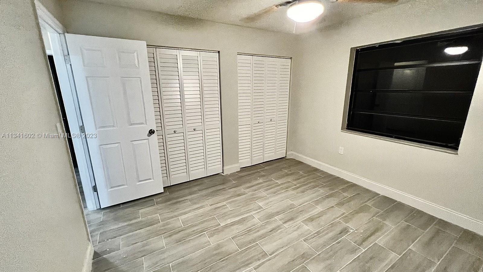 Sunset Miami, FL 33173 - Photo 38 of 41 a view of empty room with wooden floor and fan