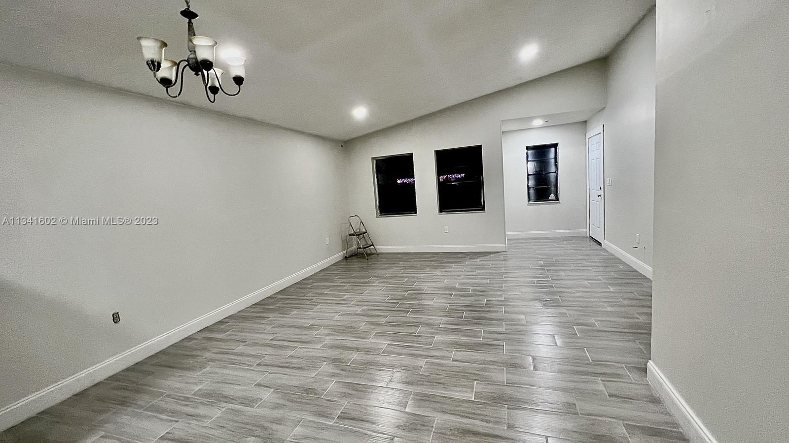 Sunset Miami, FL 33173 - Photo 4 of 41 a view of a hallway with a chandelier