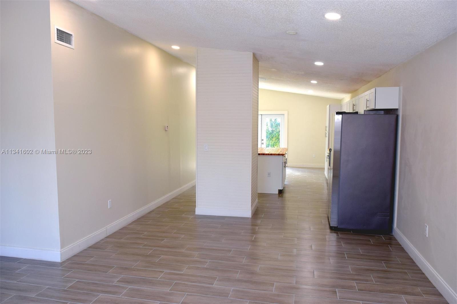 Sunset Miami, FL 33173 - Photo 7 of 41 a view of empty room with wooden floor and windows