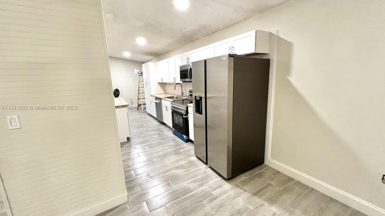 Sunset Miami, FL 33173 - Photo 8 of 41 a view of a refrigerator in kitchen and an empty room