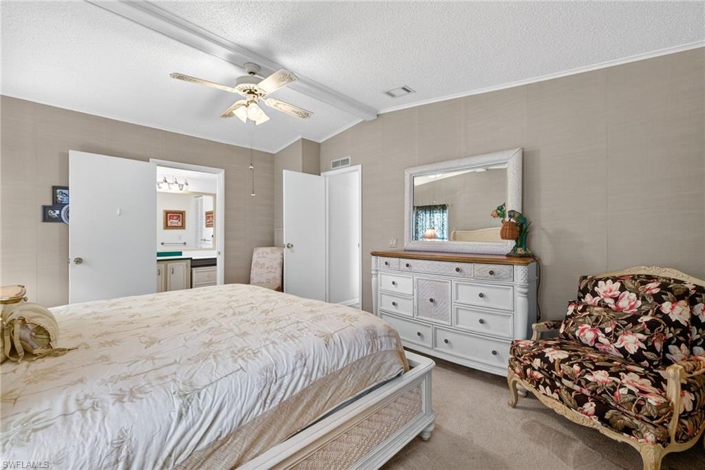 212 Oceans Boulevard, Unit 212 Naples, FL 34104 - Photo 16 of 30 a bedroom with a bed and a dresser in it