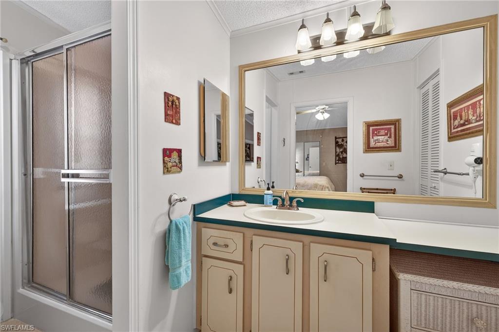 212 Oceans Boulevard, Unit 212 Naples, FL 34104 - Photo 17 of 30 a bathroom with a sink double vanity and a mirror