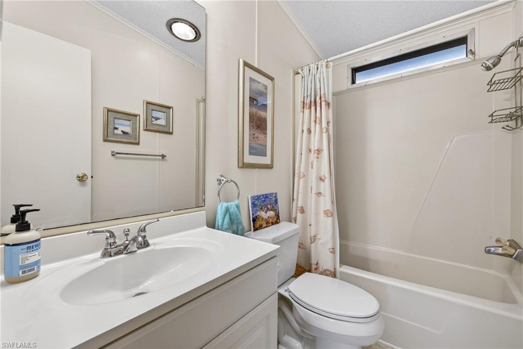 212 Oceans Boulevard, Unit 212 Naples, FL 34104 - Photo 19 of 30 a bathroom with a sink toilet and shower
