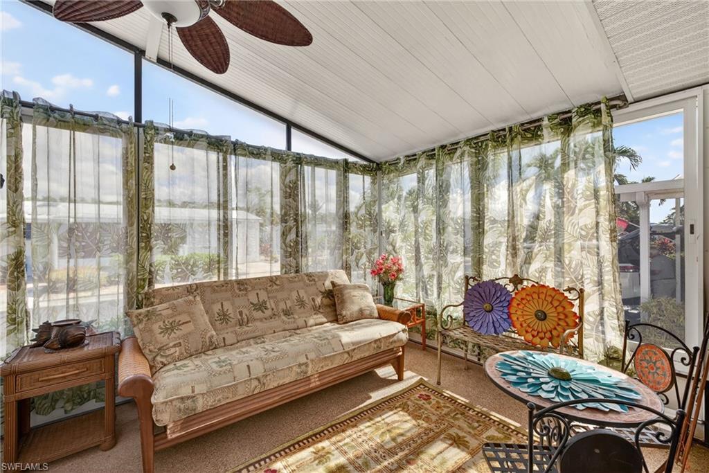 212 Oceans Boulevard, Unit 212 Naples, FL 34104 - Photo 20 of 30 a living room with furniture and a large window