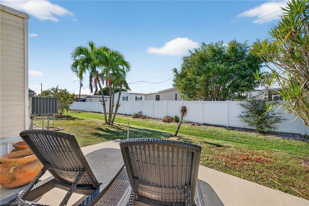 212 Oceans Boulevard, Unit 212 Naples, FL 34104 - Photo 24 of 30 a view of a chair and table on the wooden floor