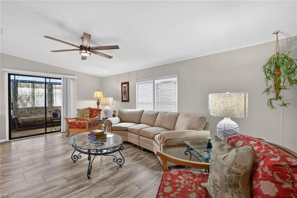 212 Oceans Boulevard, Unit 212 Naples, FL 34104 - Photo 4 of 30 a living room with furniture and wooden floor