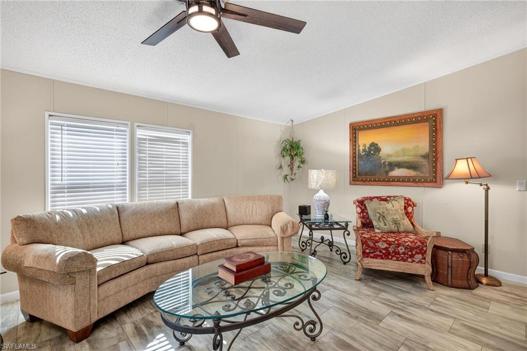212 Oceans Boulevard, Unit 212 Naples, FL 34104 - Photo 7 of 30 a living room with furniture and a window