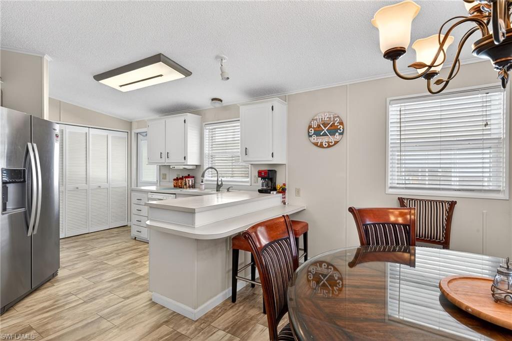 212 Oceans Boulevard, Unit 212 Naples, FL 34104 - Photo 9 of 30 a kitchen with stainless steel appliances granite countertop a sink a stove and refrigerator