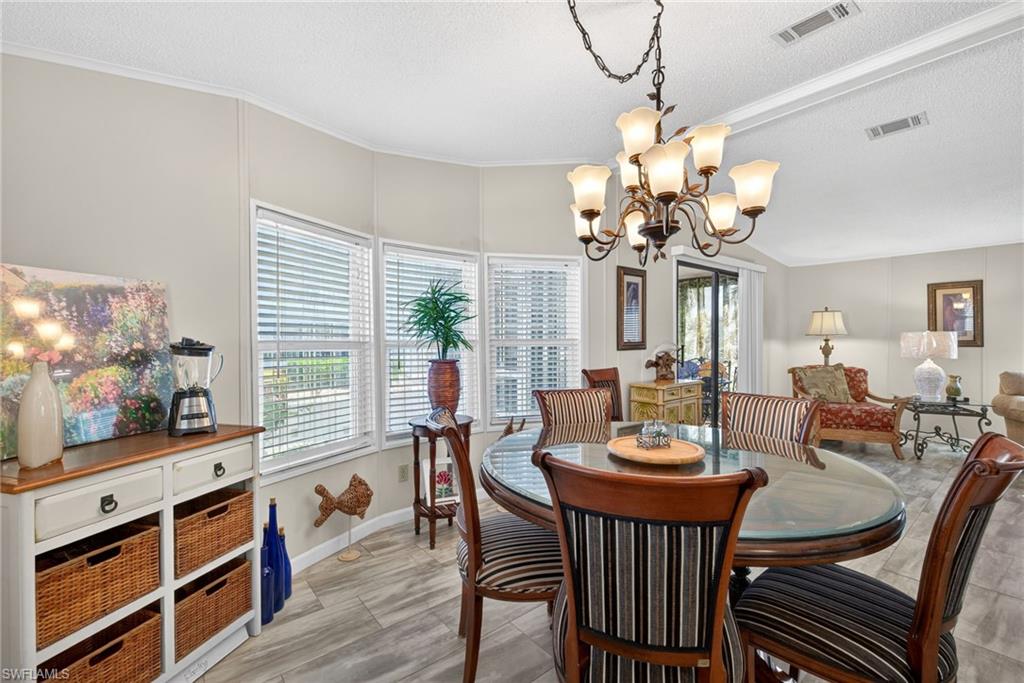 212 Oceans Boulevard, Unit 212 Naples, FL 34104 - Photo 10 of 30 a view of a dining room with furniture and wooden floor