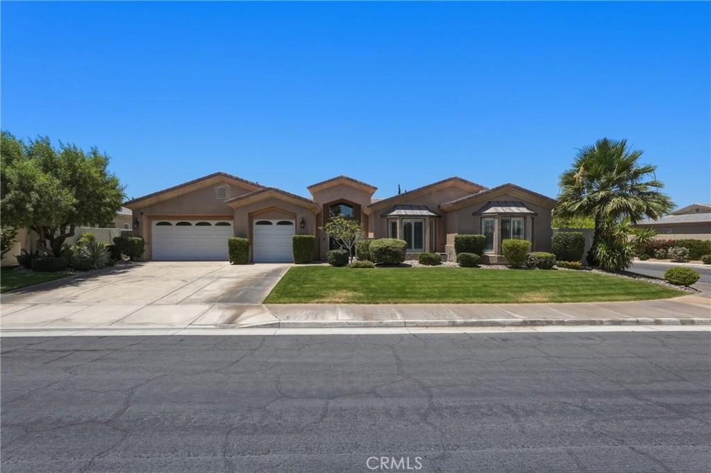 9 Orleans Road Rancho Mirage, CA 92270 - Photo 2 of 71 a front view of a house with a yard and garage