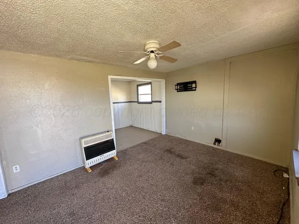a view of empty room with ceiling fan