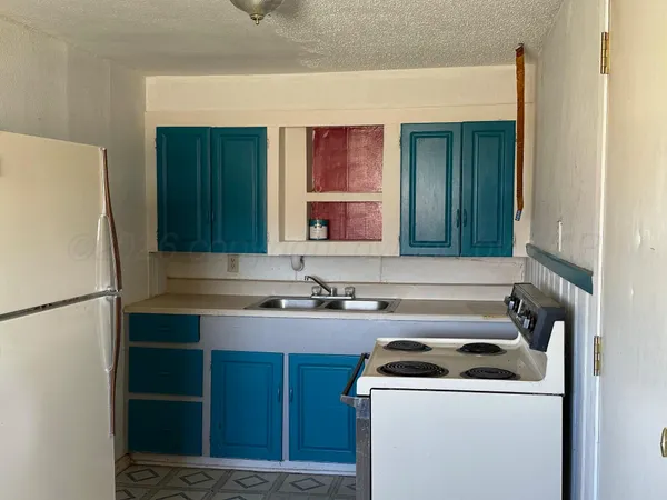 a kitchen with a sink and a refrigerator