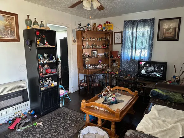 a living room with furniture a rug and a window