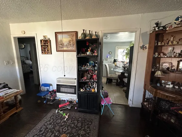 a living room with lots of storage and utility room