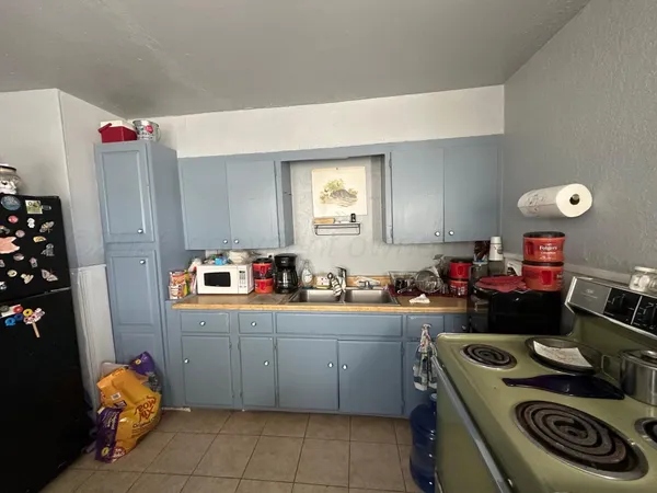 a kitchen that has a sink and a stove