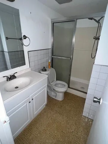 a bathroom with a sink and mirror with toilet