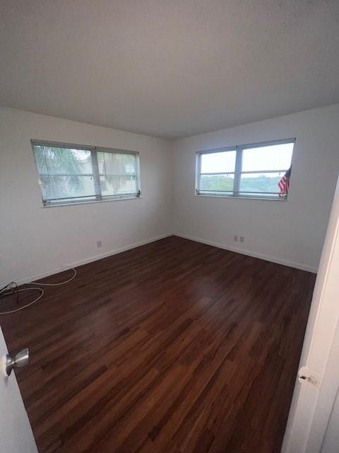 2615 Northeast 3rd Street, Unit 412 Boynton Beach, FL 33435 - Photo 8 of 14 an empty room with wooden floor and windows