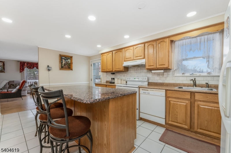 11 Cemetery Road Blairstown, NJ 07825 - Photo 23 of 34 a kitchen with stainless steel appliances granite countertop wooden cabinets a stove top oven a sink and dishwasher