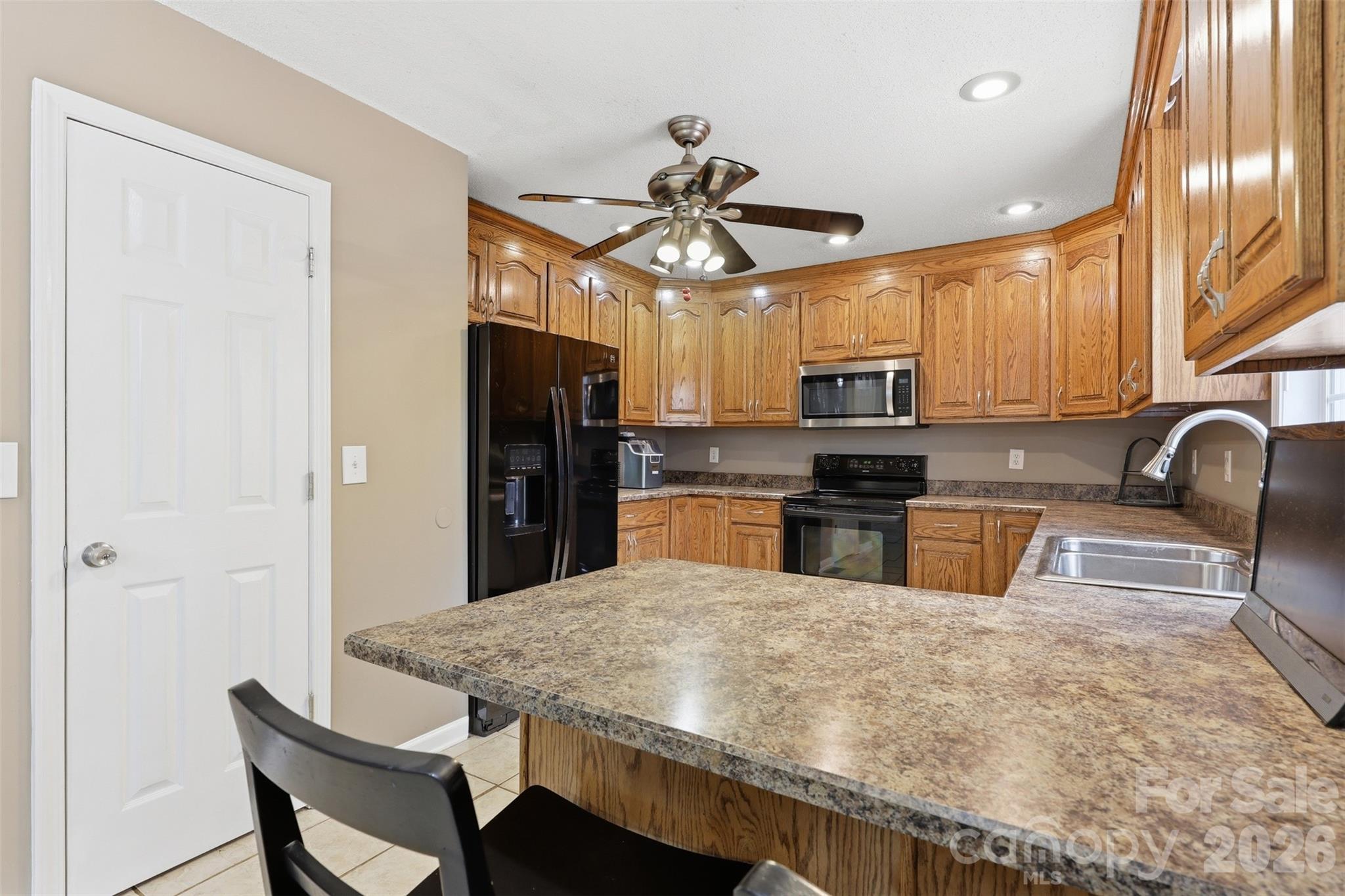 1214 Eastcreek Road Fort Lawn, SC 29714 - Photo 6 of 28 a kitchen with stainless steel appliances granite countertop a sink dishwasher a stove a refrigerator with a dining table and chairs