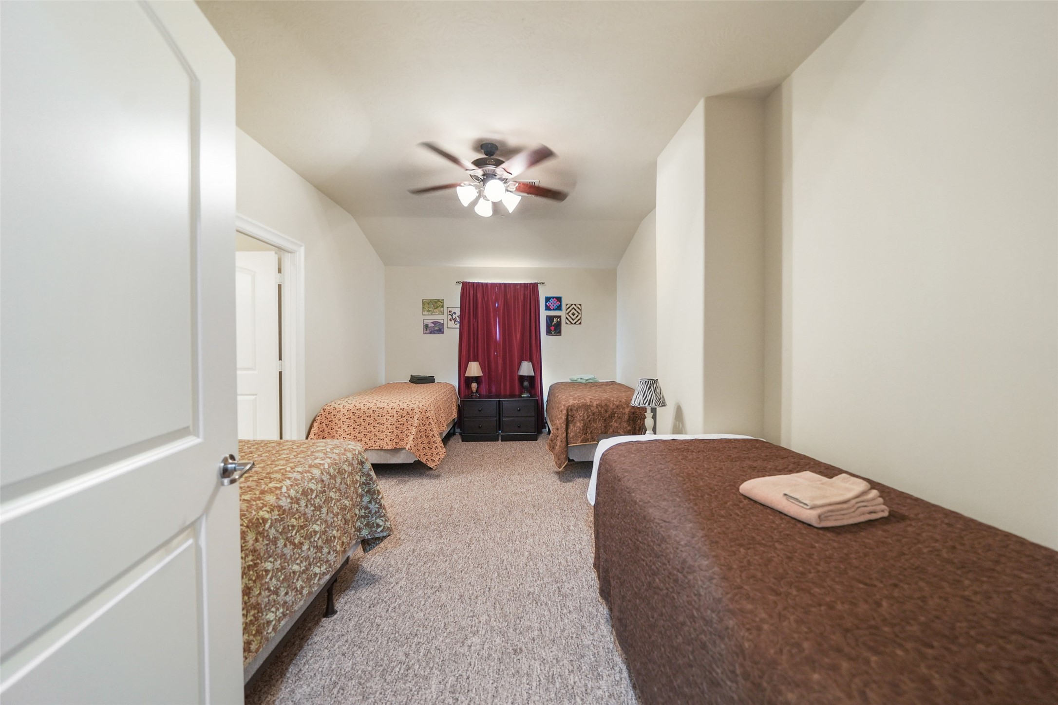 26250 A Riley Road Waller, TX 77484 - Photo 43 of 50 Retreat bedroom with plush carpet; upper level hosts six expansive bedrooms suited for group stays, many with ensuite access.